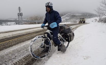 A cyclist tries to negotiate snowy roads in Lugo province.