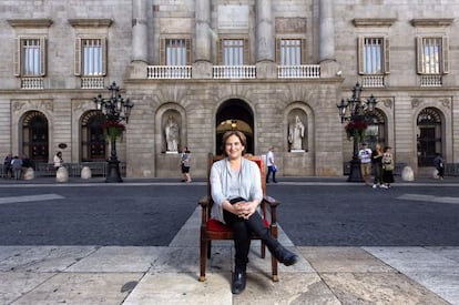 Ada Colau, sitting in front of Barcelona City Hall.