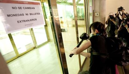 Un manifestante golpea la puerta del Banco de Espa&ntilde;a en un momento del recorrido.
