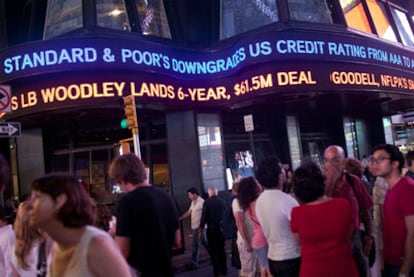 Un cartel luminoso en Times Square informa de la rebaja de la calificación de la deuda de EE UU por parte de S&P.