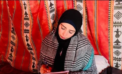 Reema Mahmoud writes a letter in one of the scenes of her short film 'Selfie', in Rafah, south of Gaza.