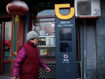 Una mujer pasa junto a una estación de DiDi, en Pekín. 
