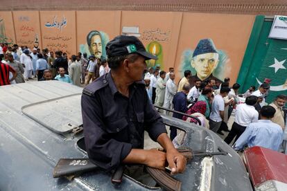 Un agente de policía hace guardia frente a un colegio electoral de Karachi (Pakistán).