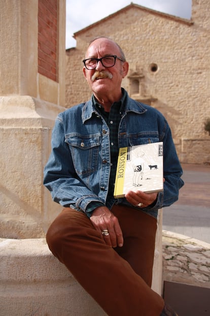 Julio César Sebastián holds the book created by his son that tells the story of his childhood in the town of Sinarcas.