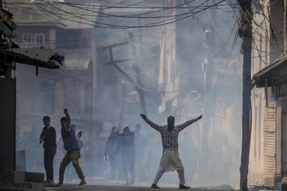Un manifestante musulmán de Cachemira grita consignas de libertad rodeado por humo de gas lacrimógeno, en Srinagar (India).