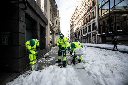 Workers clearing snow in Madrid.