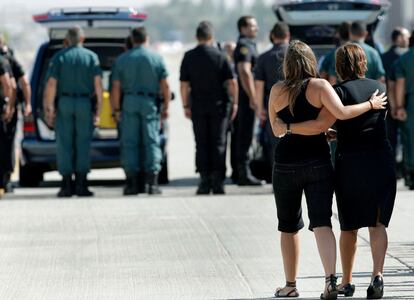 Familiares de las víctimas del atentado en Qala e Naw, en Afganistán, se abrazan durante el traslado de los féretros con los restos mortales, en la base aérea de Torrejón de Ardoz.