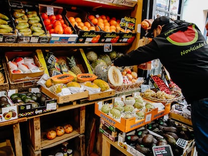 Un empleado coloca varios melones en una frutería de Madrid.