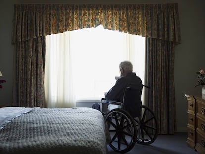 Un hombre en silla de ruedas en su habitaci&oacute;n.