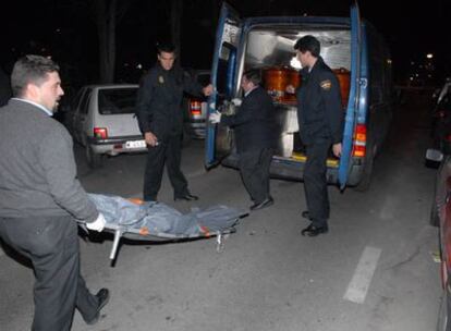 Operarios de la funeraria transportan el cuerpo de una de las víctimas de una reyerta en Móstoles.
