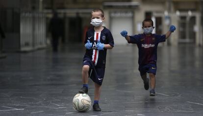 Duas crianças jogam futebol em San Sebastián.