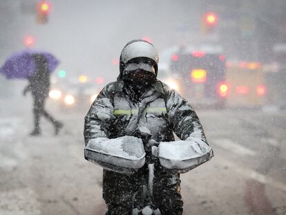 Un repartidor atraviesa trabaja en Manhattan durante la tormenta de nieve en Nueva York, el martes 13 de febrero.