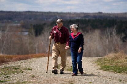 Dell and Marie Emerson walk behind their home, Thursday, April 27, 2023, in Addison, Maine. The couple is opposed to a flagpole theme park that would destroying woodlands and supplant wild blueberry barrens that have been farmed by Native Americans for 10,000 years. 