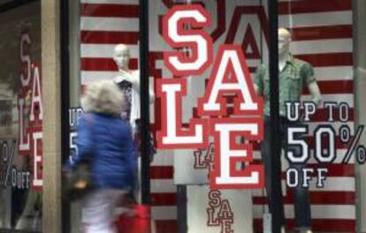 Una mujer camina frente a un escaparate en el período de rebajas en Duesseldorf (Alemania). EFE/Archivo