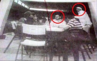 A photograph of Rodrigo Vallejo (sitting) and La Tuta (wearing hat)