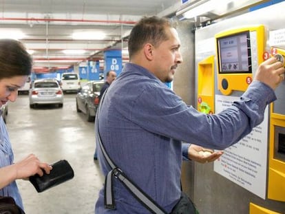 Usuarios en un aparcamiento de Empark pagando la estancia de su vehiculo.