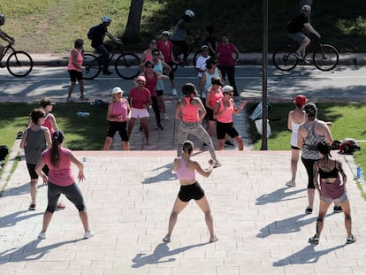Un grupo de mujeres practica zumba en un parque.