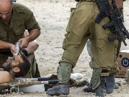 Soldados israel&iacute;es evac&uacute;an a un herido.