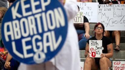 Protesters hold signs as Barbara DeVane, of the Tallahassee National Organization for Women, speaks outside the Florida Historic Capitol in Tallahassee, Fla., during a rally protesting the Supreme Court's overturning of Roe v. Wade, Friday, June 24, 2022. (Chasity Maynard/Tallahassee Democrat via AP)