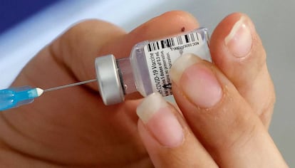 A healthcare worker prepares a dose of COVID-19 vaccine at Maccabi 