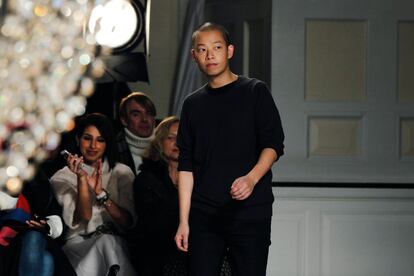 Designer Jason Wu acknowledges the crowd after a presentation of the Jason Wu Autumn/Winter 2013 collection during New York Fashion Week