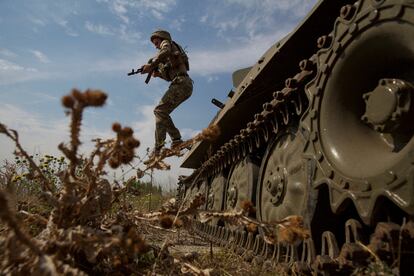 Un soldado ucranio salta de un vehículo militar cerca de una línea de frente en la región de Mykolaiv (Ucrania), el miércoles.