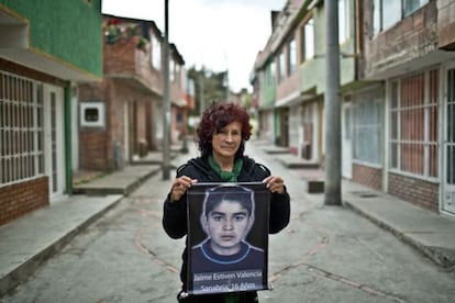 María Sanabria holds up a picture of her son, Jaime Estiven Valencia, who was killed aged 16 in 2008.