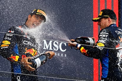 Red Bull's Max Verstappen celebrates on the podium after winning the Japanese Grand Prix along with second-placed Sergio Pérez.