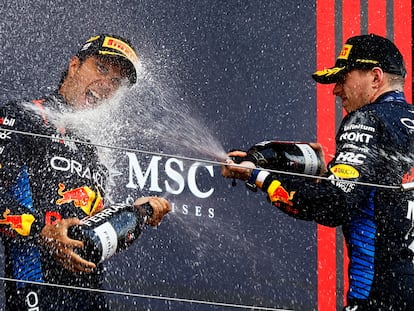 Red Bull's Max Verstappen celebrates on the podium after winning the Japanese Grand Prix along with second-placed Sergio Pérez.