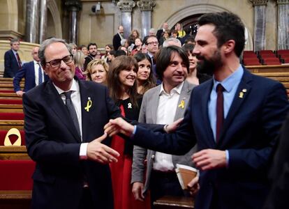 El nuevo presidente de la Generalitat, Quim Torra, saluda al presidente del Parlament, Roger Torrent (i), tras ser elegido por mayoria simple en la segunda sesión del debate de investidura celebrado en el Parlament de Cataluña.