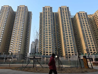 A woman walks past an Evergrande Group residential complex called Evergrande Palace in Beijing on January 29, 2024.