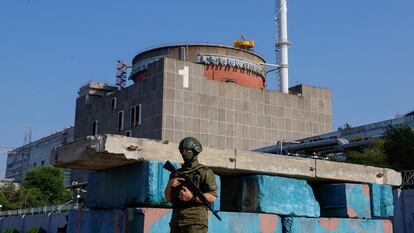 A Russian soldier stands guard at a checkpoint near the Zaporizhzhia Nuclear Power Plant, June 15, 2023.