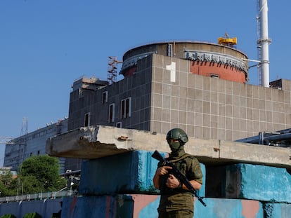 A Russian soldier stands guard at a checkpoint near the Zaporizhzhia Nuclear Power Plant, June 15, 2023.