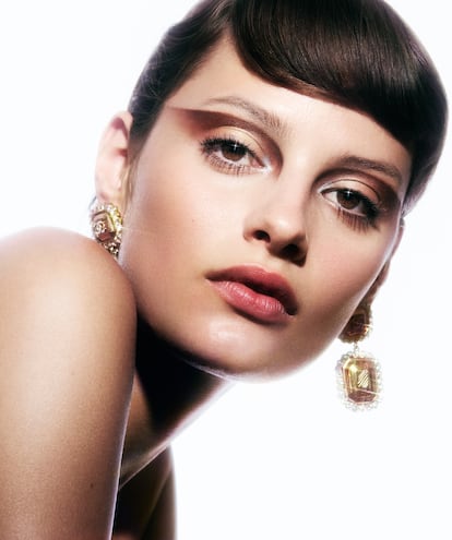 Ahumado invertido con la paleta Couture de Les 4 Ombres Boutons y el plateado de Stellaire en el lagrimal. Unos toques de máscara de pestañas Noir Allure, colorete Joues Contraste (tono In Love) y labial hidratante Rouge Coco Bloom (tono Sweetness). Pendientes dorados con cristales. Todo de CHANEL.