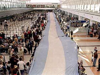 Empleados de Aerolíneas extienden una bandera argentina, el jueves pasado, en el aeropuerto de Buenos Aires.