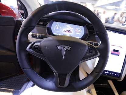 The logo of Tesla carmaker is seen inside a car at the Top Marques fair in Monaco
