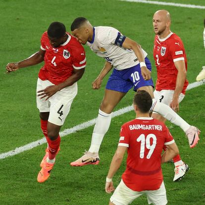 DUSSELDORF, GERMANY - JUNE 17: (EDITORS NOTE: Image contains graphic content.) Kylian Mbappe of France clashes heads with Kevin Danso of Austria during the UEFA EURO 2024 group stage match between Austria and France at Düsseldorf Arena on June 17, 2024 in Dusseldorf, Germany. (Photo by Lars Baron/Getty Images)