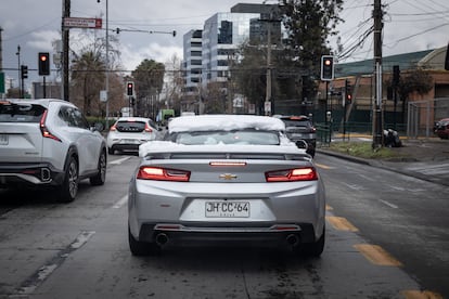Un auto con nieve sobre él, transita por las calles de Lo Barnechea, esta mañana nevada, en Santiago.