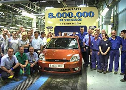 Trabajadores de Ford en Almussafes, ayer, junto al coche que hace el número ocho millones de los fabricados en la planta.