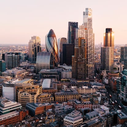 UK, London, elevated view over city financial district skyline at sunset