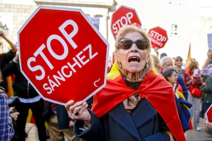 A woman holds a sign with the slogan "Stop Sanchez" during the rally in Plaça Sant Jaume in Barcelona. According to the local police, 6,000 people took to the streets in the Catalan capital.