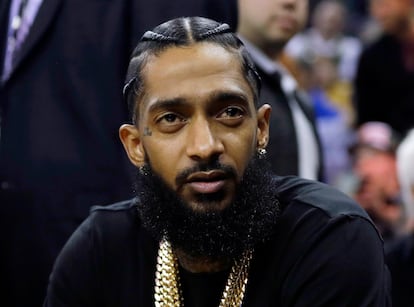 Rapper Nipsey Hussle attends an NBA basketball game between the Golden State Warriors and the Milwaukee Bucks in Oakland, Calif., March 29, 2018.