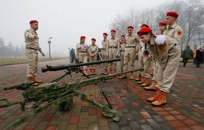 Miembros del movimiento patriótico infantil 'Unarmy' observan un arma durante una exhibición militar en la ciudad controlada por militantes pro-rusos de Donetsk (Ucrania).