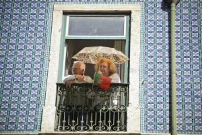 Una pareja observa la manifestación del Primero de Mayo en Lisboa, Portugal hoy, jueves 1 de mayo de 2014.