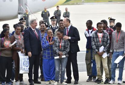 El ministro de Interior italiano (centro) y el ministro de Exteriores luxemburgu&eacute;s con el grupo de refugiados eritreos, este viernes en Roma. 