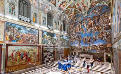 Varios trabajadores colocan los tapices de Rafael en la Capilla Sixtina, en el Vaticano.