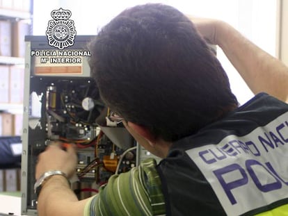 An officer seizing computer material.