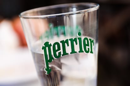 Perrier logo is seen on a glass of water in a restaurant in Madrid, Spain on June 28, 2022. (Photo by Jakub Porzycki/NurPhoto via Getty Images)