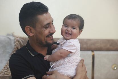 Khalil al-Sawadi plays with his adopted daughter Afraa in Jinderis, Syria, on Saturday, Aug. 5, 2023