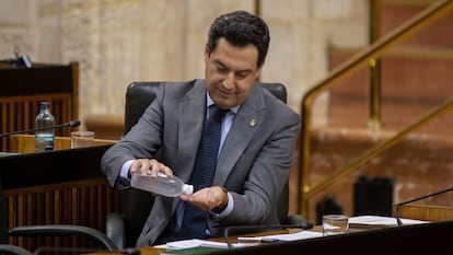 El presidente de la Junta de Andalucía, Juan Manuel Moreno, se desinfecta las manos durante la sesión de control al Gobierno, este miércoles.